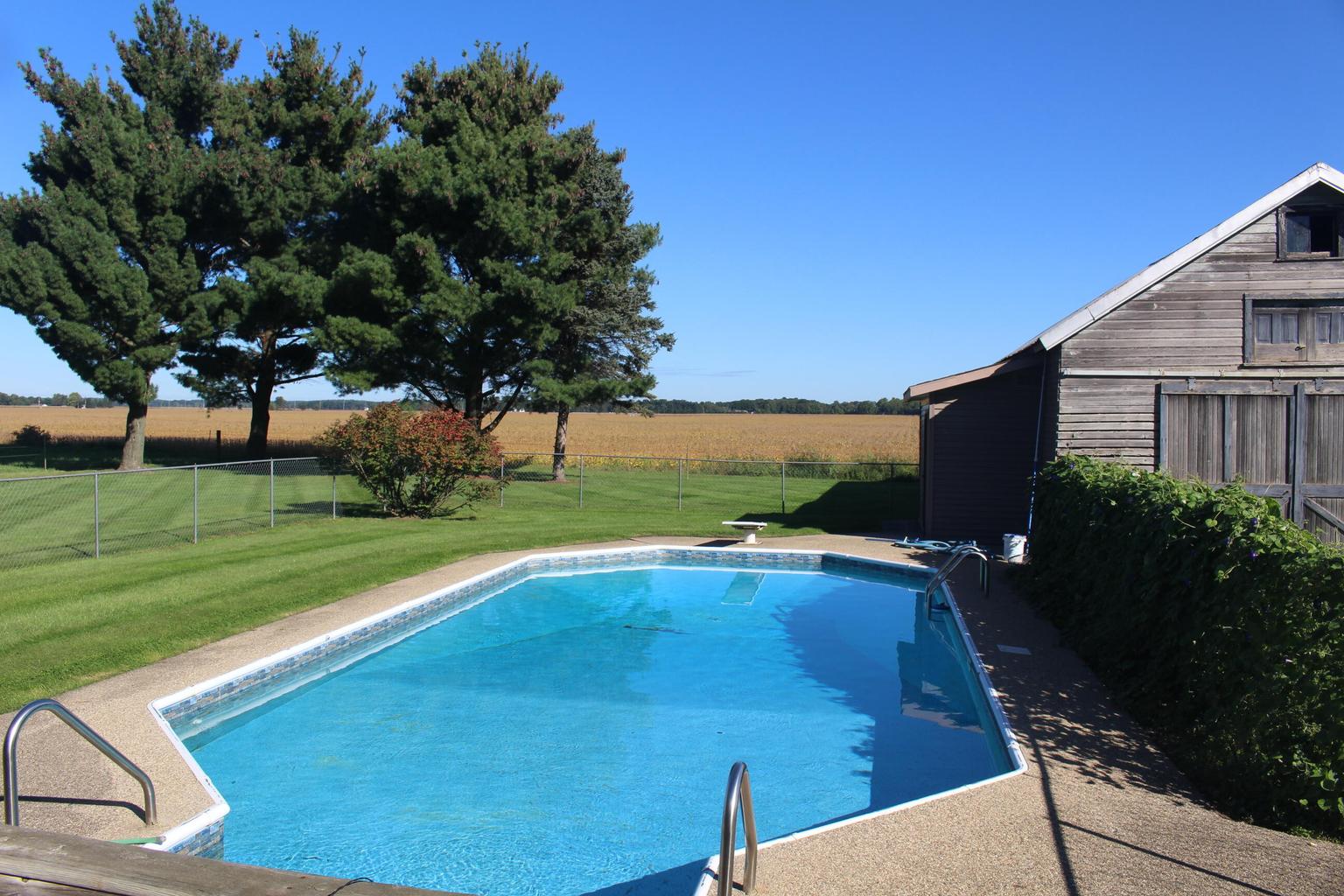 swimming pool with pines in background