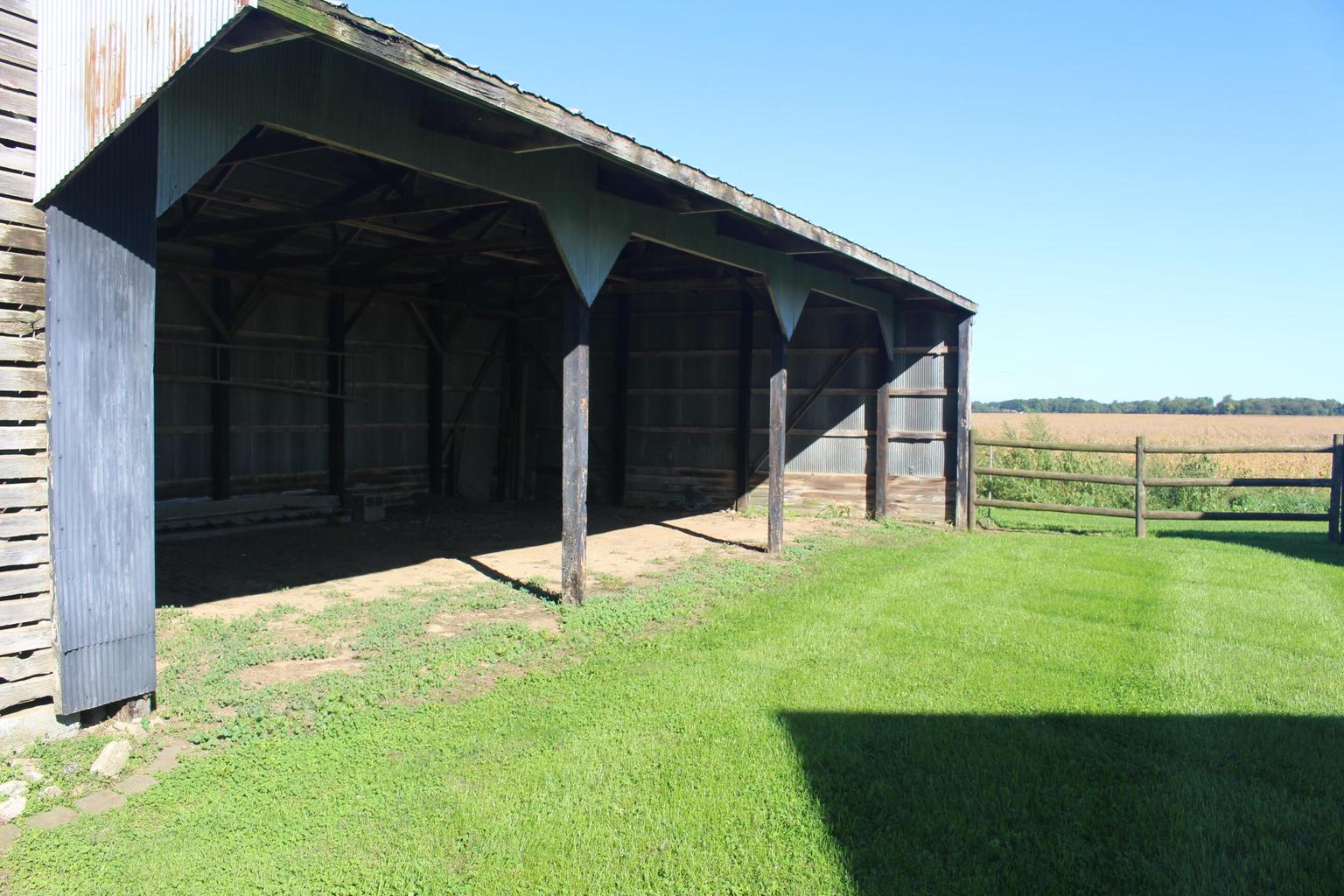 open barn by green lawn