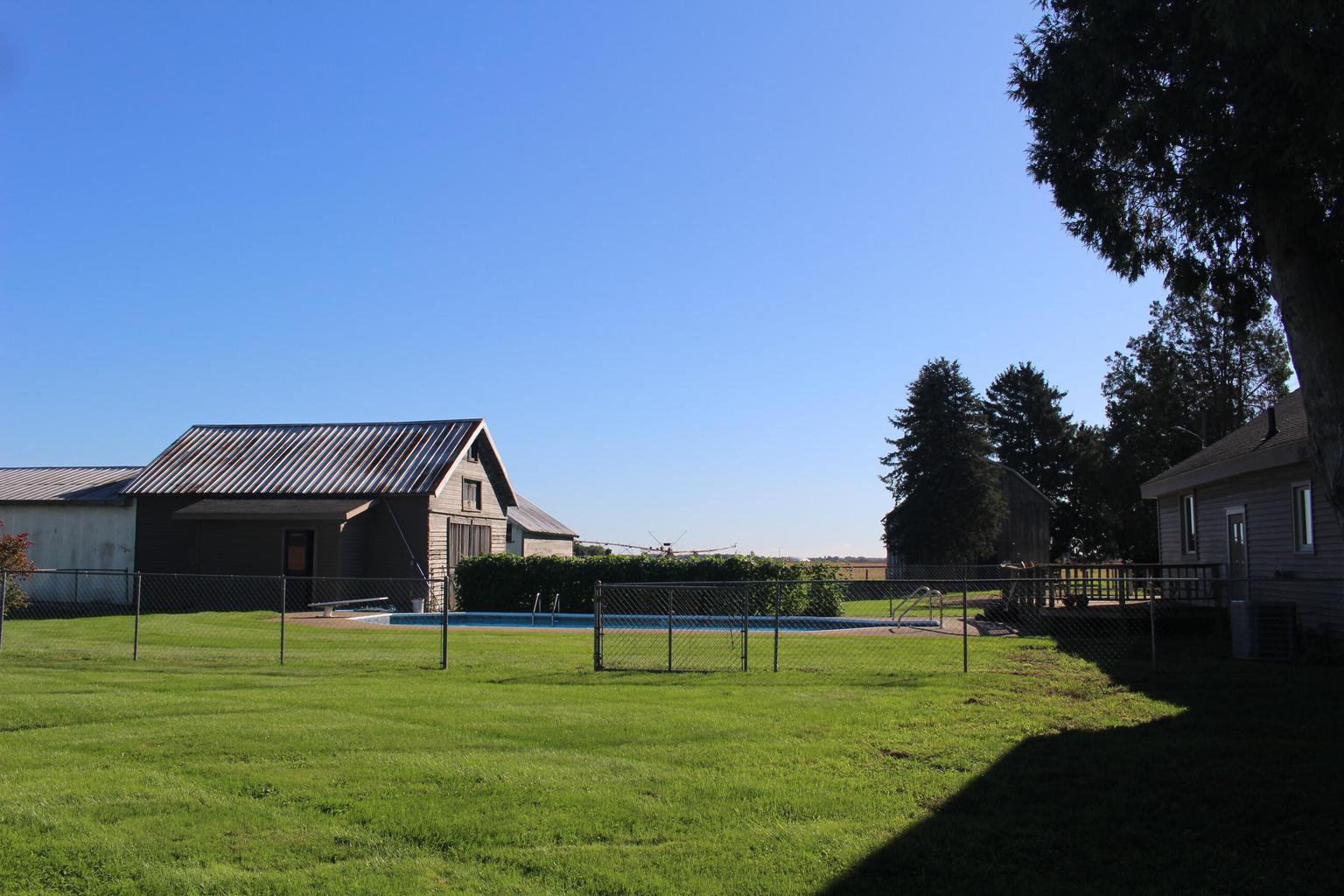 fenced back yard with pool