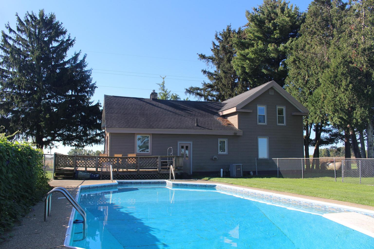 rear of home over blue swimming pool